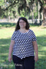 Woman modeling top length of Hope pattern with black and white polka dot fabric.